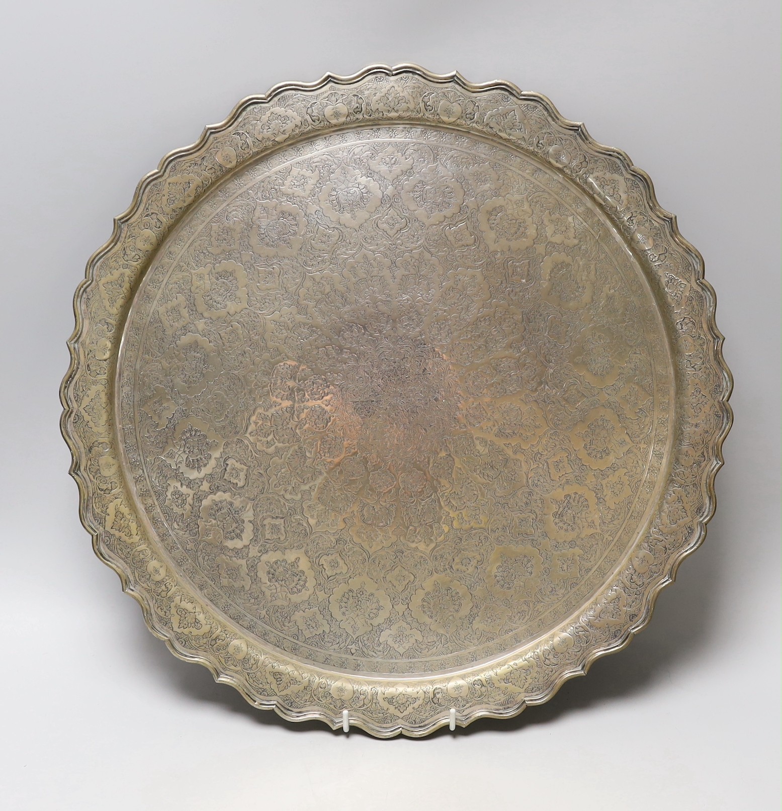 A Persian engraved white metal tray, 43.7cm, 49oz.